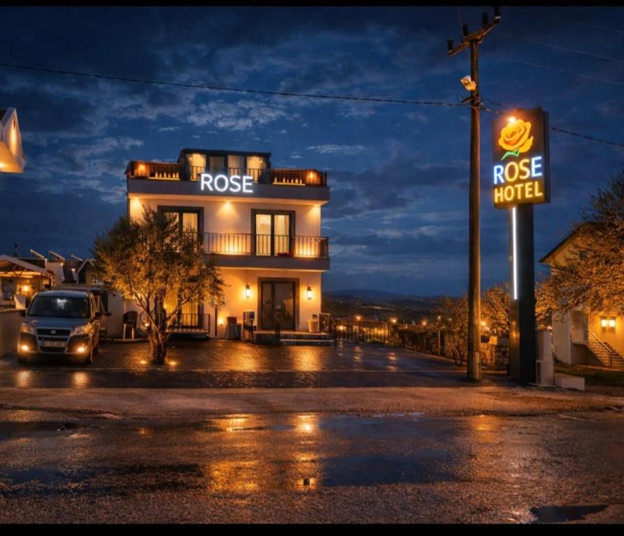 a building with a rosie motel sign at night at ROSe OTEL in Ezine