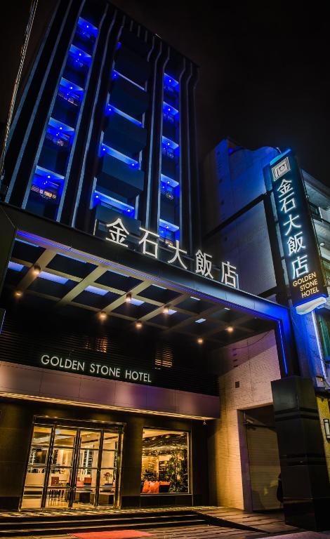 a building with blue lights on top of it at Golden Stone Hotel in Kaohsiung