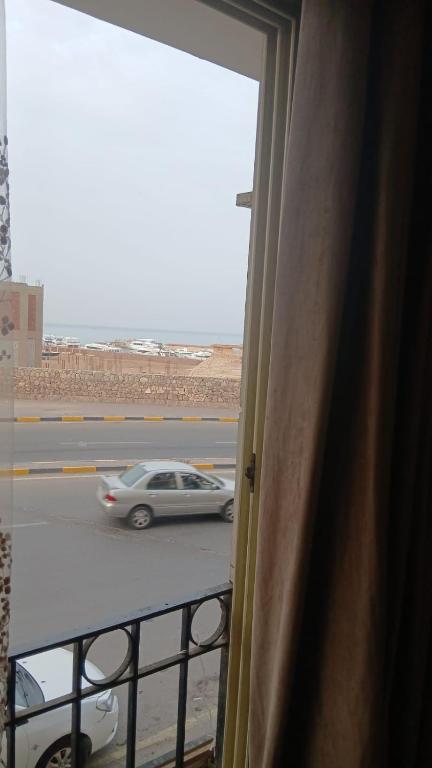 a car driving down a street from a balcony at فينوس in Hurghada