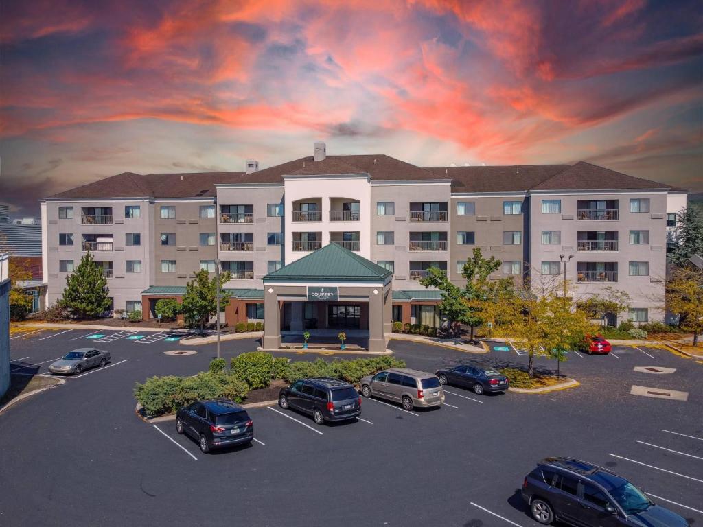 a large building with cars parked in a parking lot at Country Inn & Suites by Radisson, Convention Center in Altoona