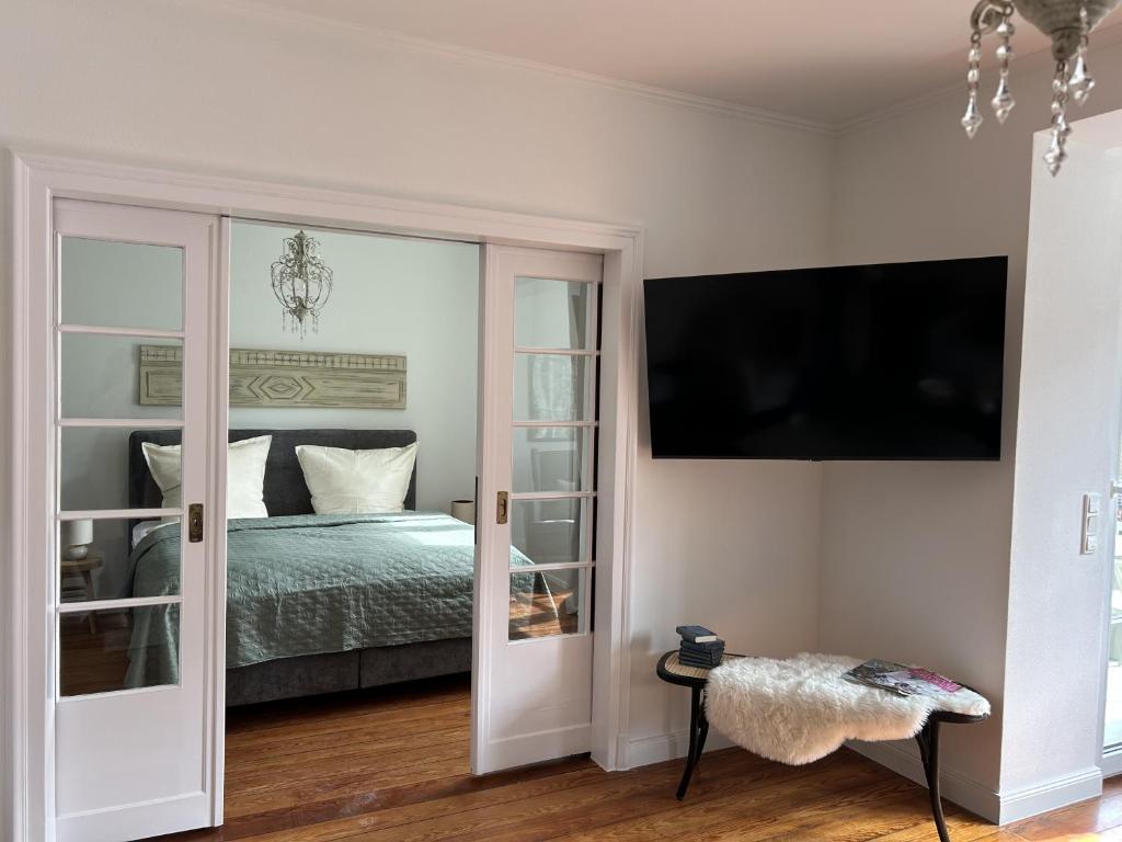 a bedroom with a bed and a sliding glass door at Residenz Moselliebe Traben in Traben-Trarbach