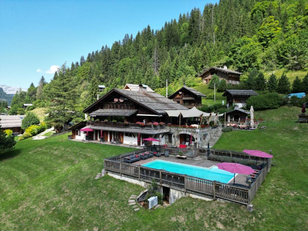 an aerial view of a house with a swimming pool at Les Chalets de la Serraz in La Clusaz