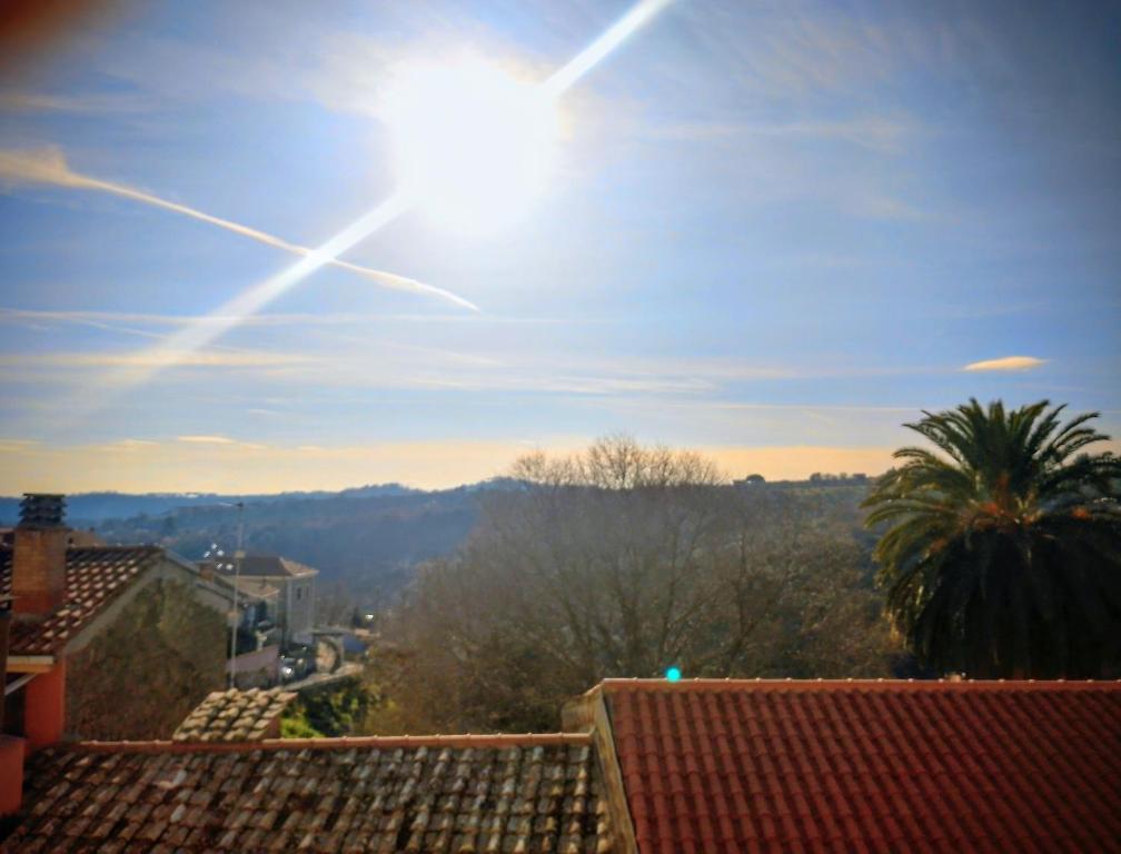 a view of the sun from the roof of a building at Jerry & Titty house in Capena