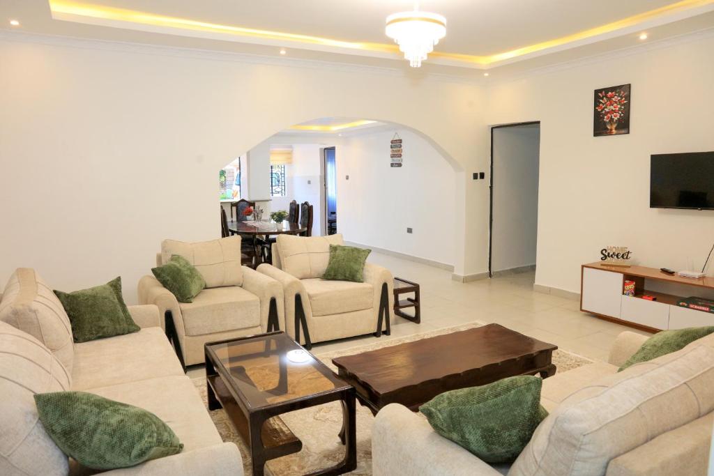 a large living room with couches and a table at Asili House in Sagana
