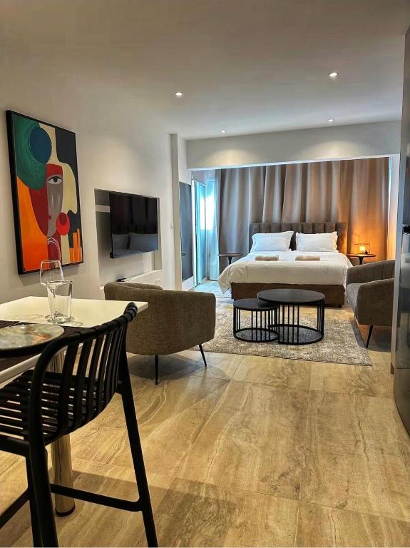 a bedroom with a bed and a living room at J Aurora in Nicosia