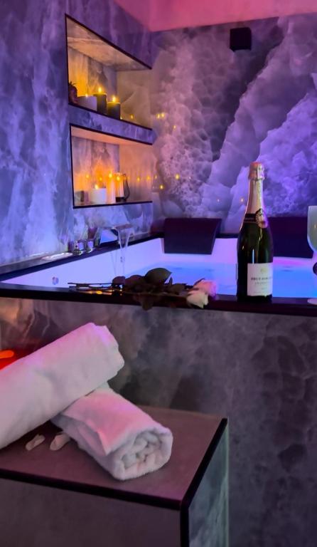 a bar with a bottle of wine on a table at Aura Spa Oberhausen Premium in Oberhausen