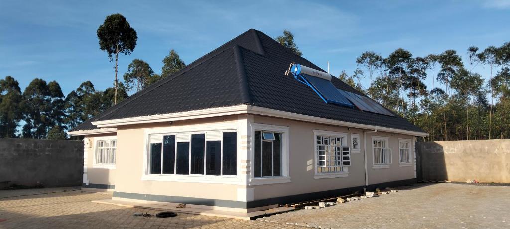a small house with a roof on top of it at Sam's comfy homes in Eldoret