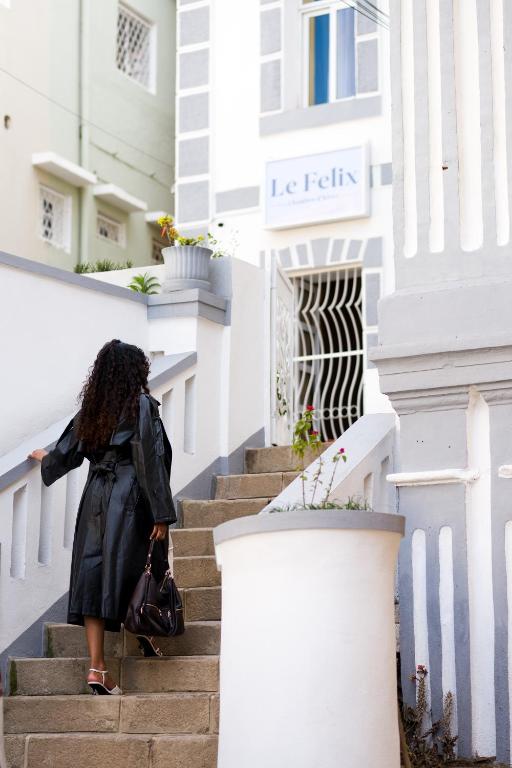 a woman walking down the stairs of a building at Le felix in Antananarivo