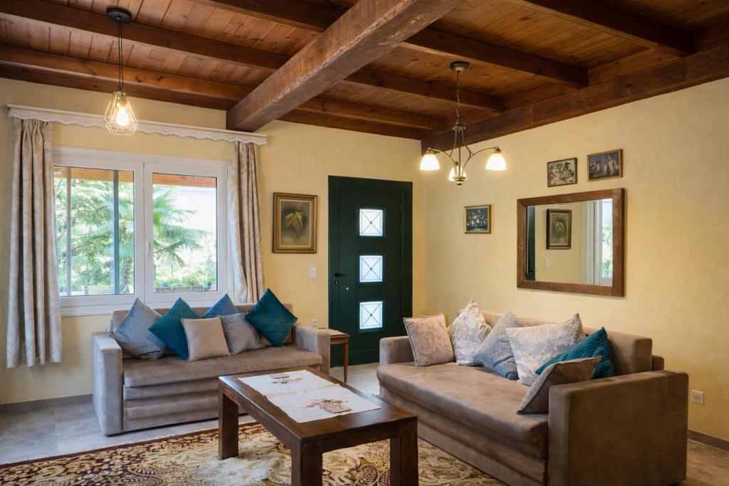 a living room with two couches and a table at Villa Dorothy 360 -Mountain Escape in Polydrosos in Polydrossos