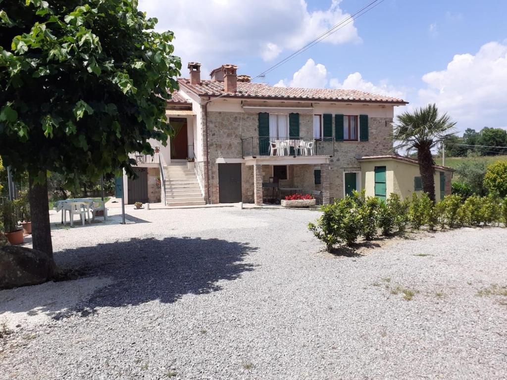 a large stone house with a large driveway at Costa Del Sole 48 in Camporsevoli