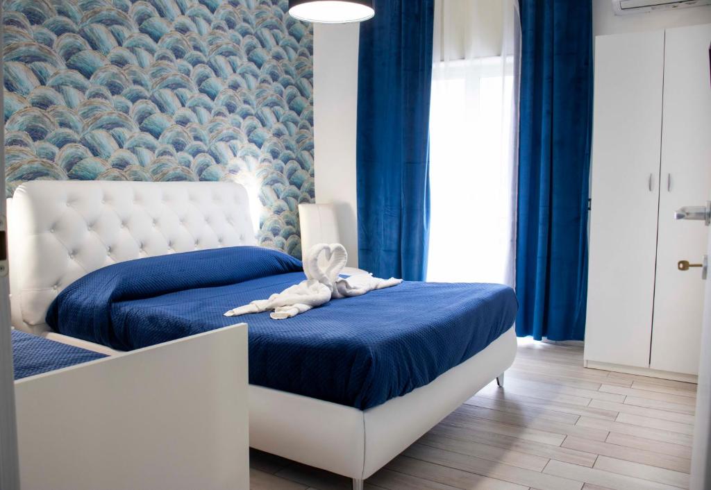a bedroom with a bed with a teddy bear on it at B & B Victoria in Pompei
