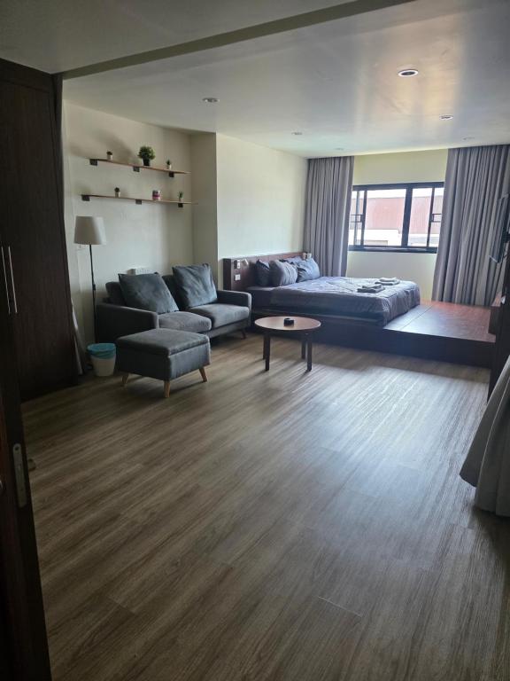 a living room with a couch and a table at Thaiger House Studios in Bangkok