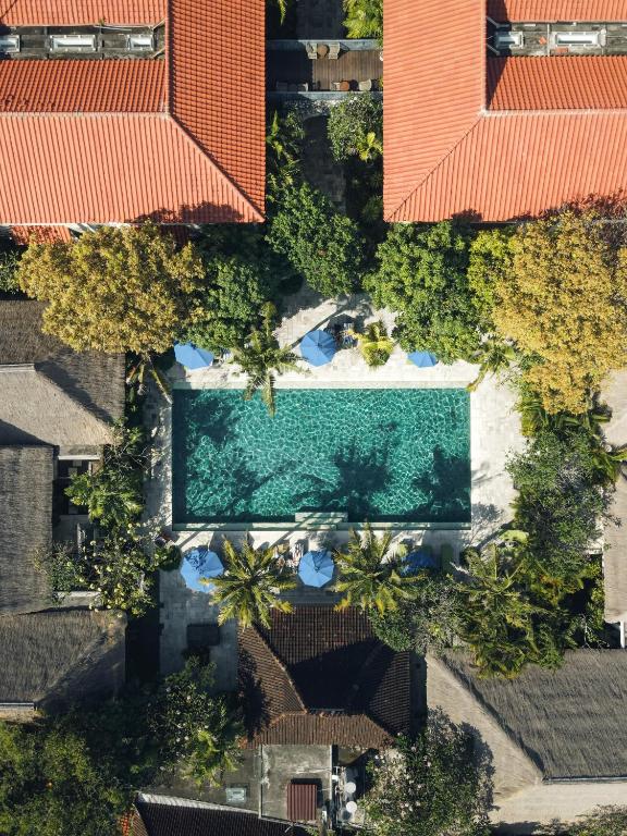 an overhead view of a swimming pool with orange roofs at Sudamala Resort, Sanur, Bali in Sanur