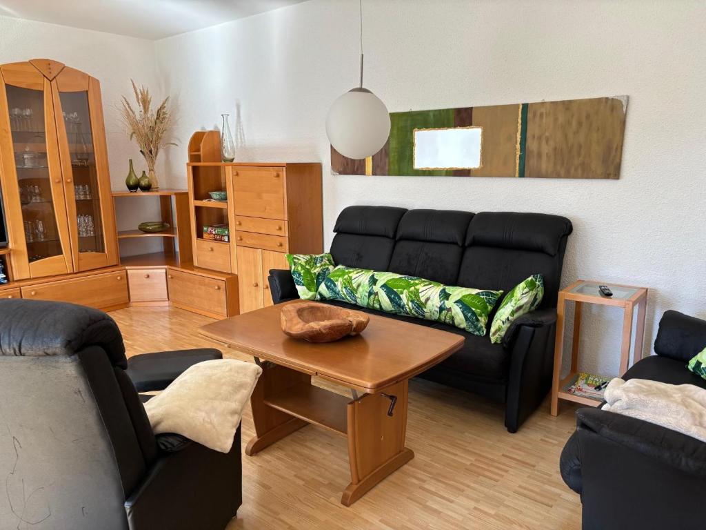 a living room with a couch and a table at Ferienwohnung Waldliebe in Waldkirchen