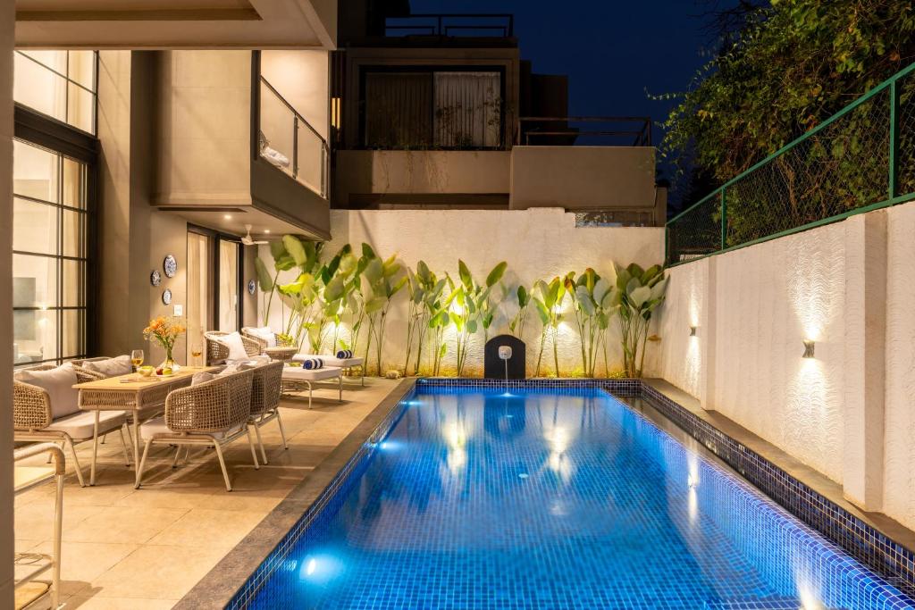a swimming pool in the middle of a house at Lindsay Manor Santo Sovrano 4BHK Heated Pool in Vagator