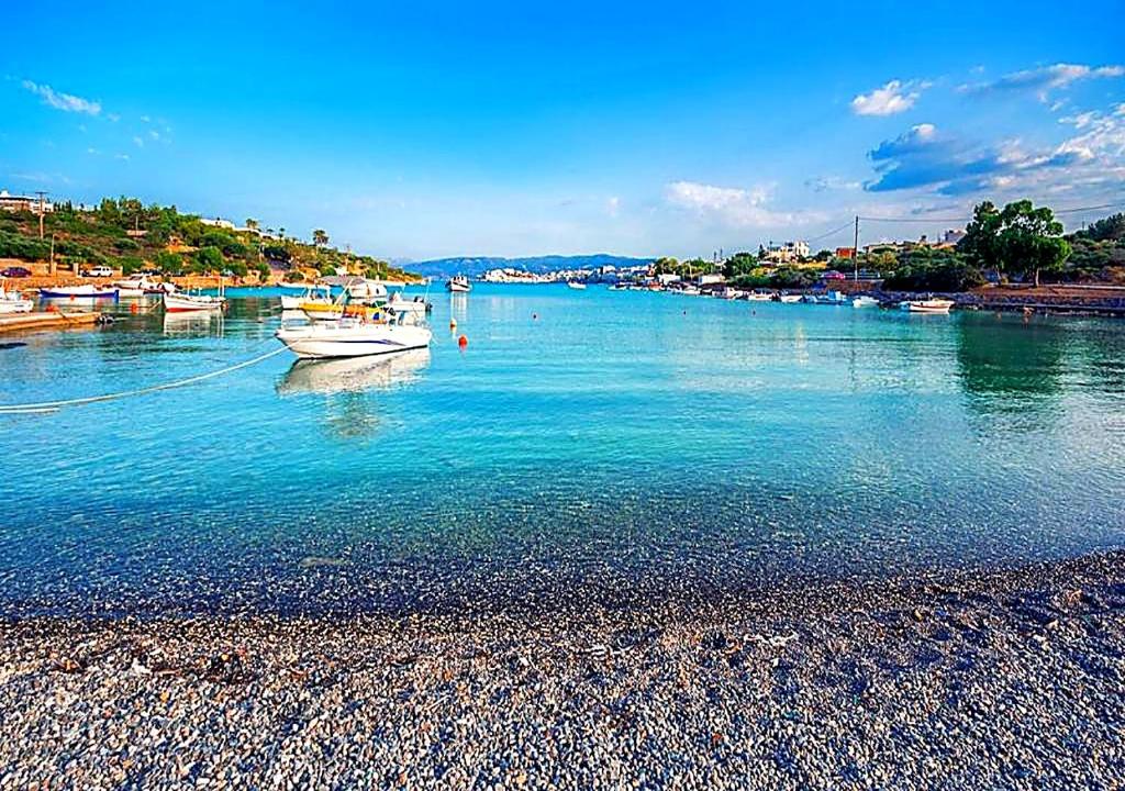 a boat is docked in a body of water at SUMMER Home in Agios Nikolaos