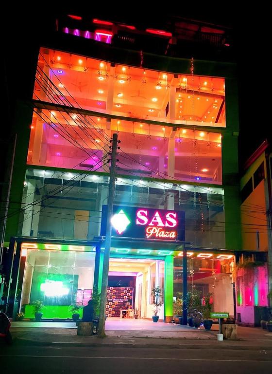 a gas station with a neon sign in front of it at Sas Tower Hotel in Trincomalee
