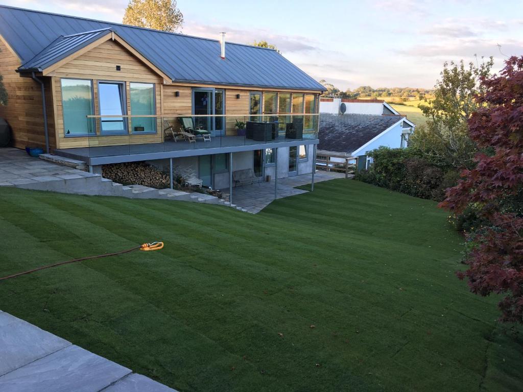 a house with a yard with green grass at Timbers in Truro