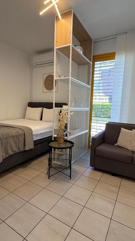 a living room with a bed and a couch at NiceStay in Lugano