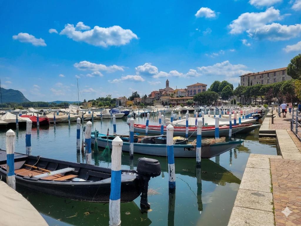 a group of boats are docked in a harbor at Light on Lake Iseo in Clusane sul Lago