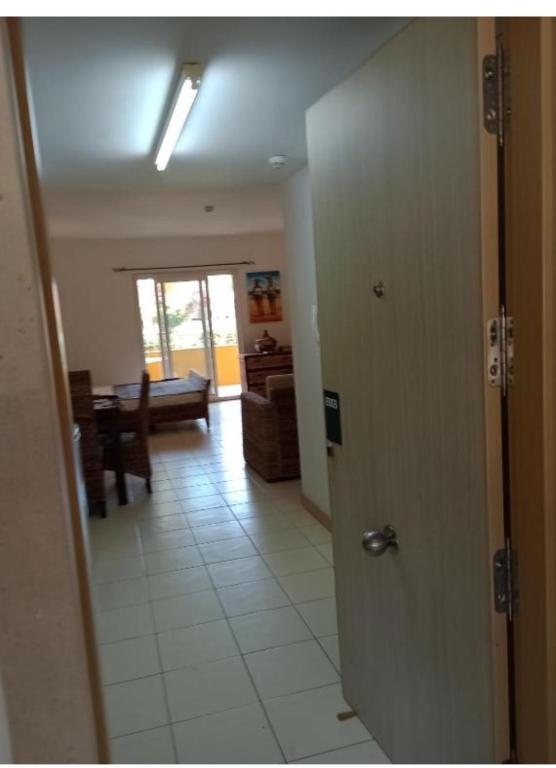 a hallway with a door and a room with a table at Ground floor Studio Vila Verde in Prainha