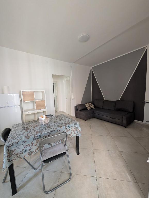 a living room with a table and a couch at Dietro l'Angolo in Millesimo