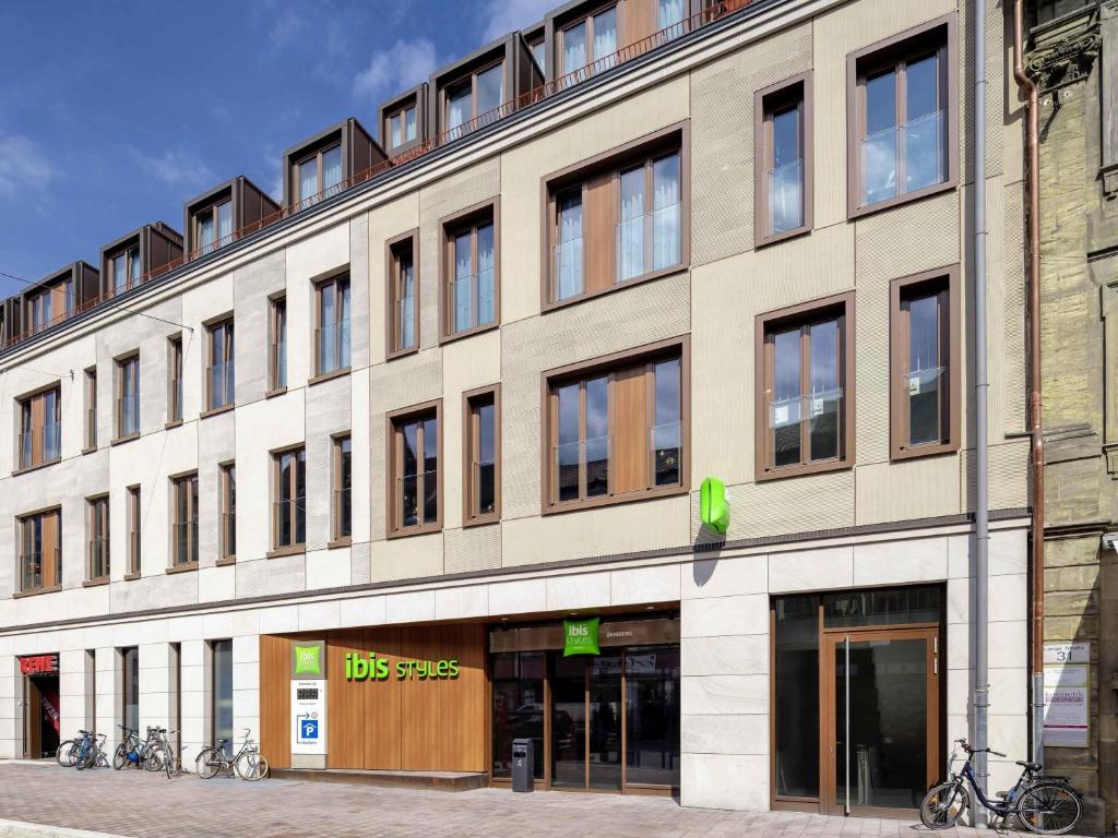 a large building with bikes parked outside of it at ibis Styles Bamberg in Bamberg