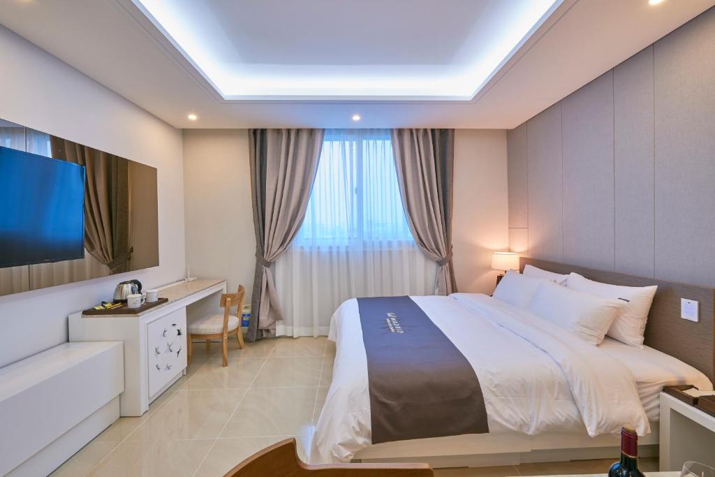 Postel nebo postele na pokoji v ubytování Gwangju Madrid Hotel