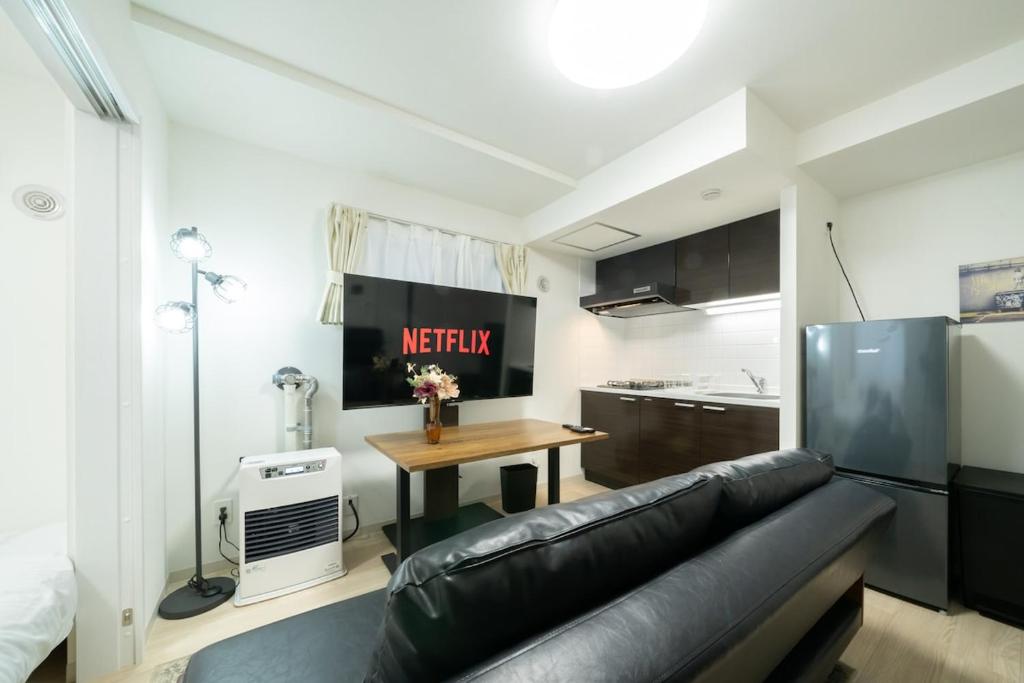 a living room with a couch and a table at Laguna Verde Misono 103 in Sapporo
