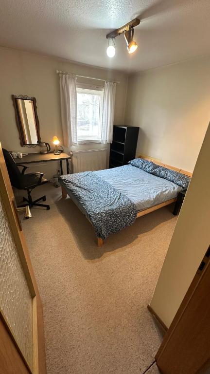 a bedroom with a bed and a desk and a window at aba ZARA in Hamburg