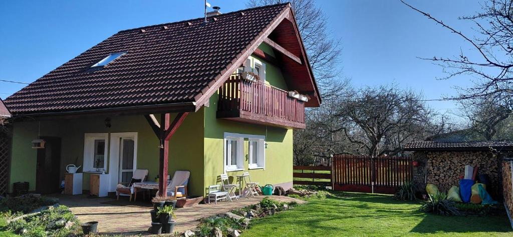 a small yellow and green house with a balcony at Apartmán Hodoňovice in Frýdek-Místek