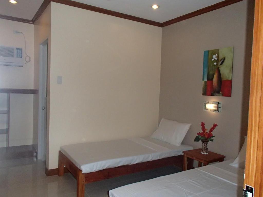 Postel nebo postele na pokoji v ubytování Malapascua Starlight Resort