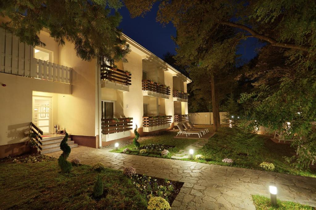 a large house with lights in the yard at night at Kompleks Negorski Banji in Gevgelija