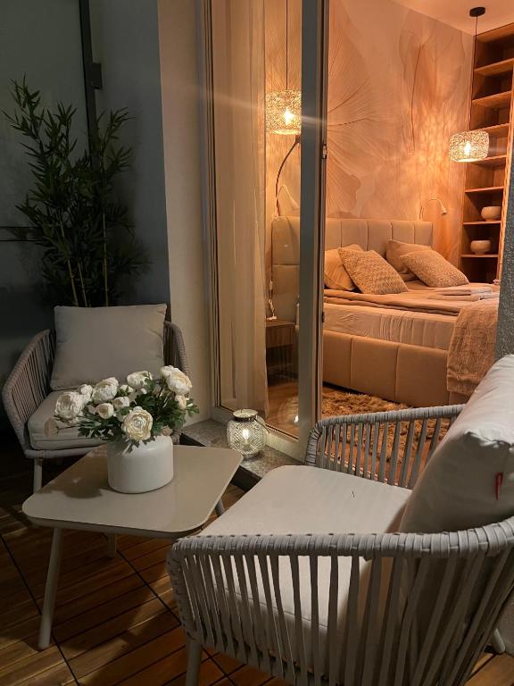 a living room with a bed and a table and chairs at SPV Rentals Premium Apartament Wołoska 3 in Warsaw