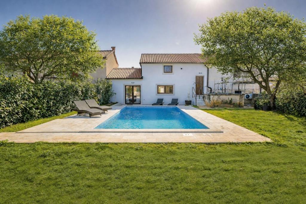 a house with a swimming pool in the yard at Villa STOCK 66 by Villsy in Štokovci