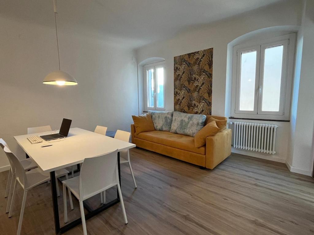 a living room with a couch and a table with a laptop at Art Residency Borgo Castello in Gorizia
