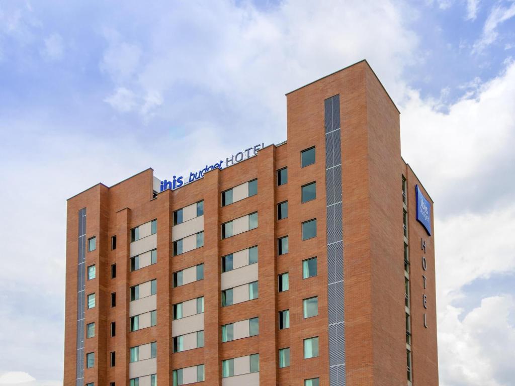 a building with a sign on the top of it at ibis budget Medellín Itagüí Metro in Medellín