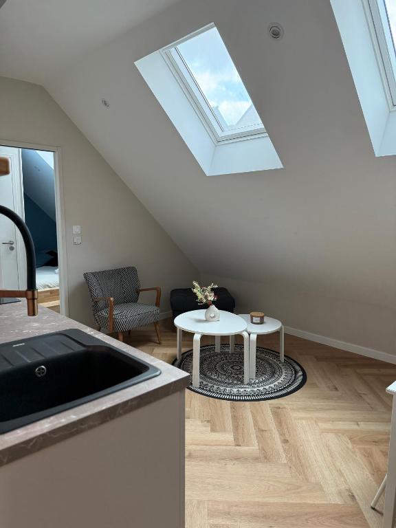a living room with a skylight and a table at Léonie-Les appart's de Léon in Landerneau