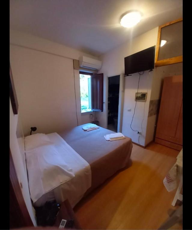 a bedroom with a large white bed in a room at Maras in Palinuro