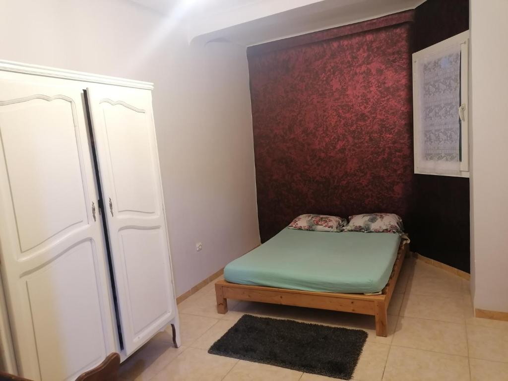 a small room with a bed and a wall at Les 4 chemins in Bejaïa