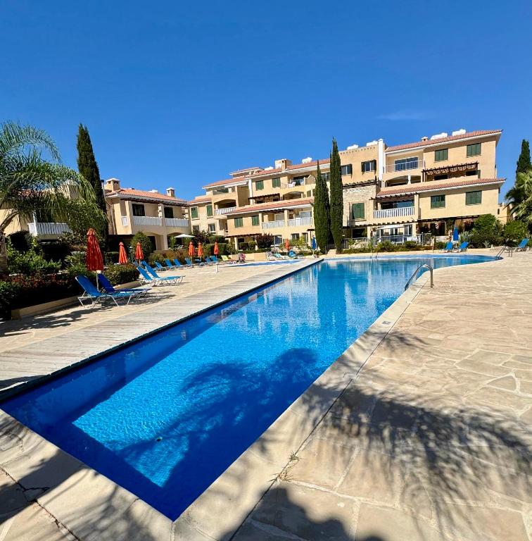 a large swimming pool in front of a building at Polis Gardens Pool Apartment in Polis Chrysochous