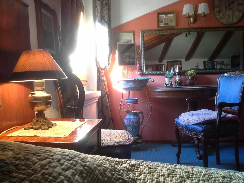a bedroom with a bed and a table with a lamp at Studios Kono in Kotor