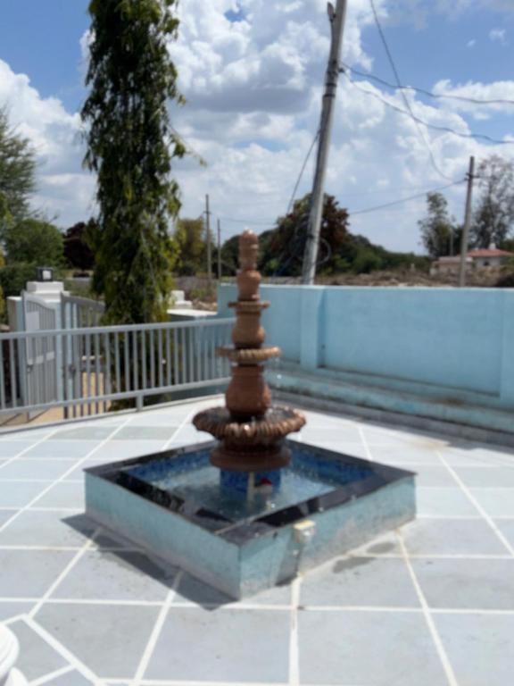 a small fountain in the middle of a patio at The Celestine Villa in Thūr