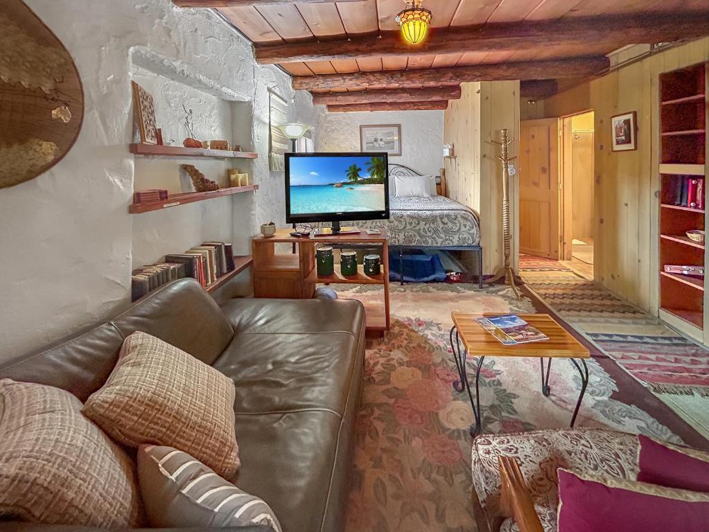 a living room with a couch and a television at Casita Adobe in Grand Junction