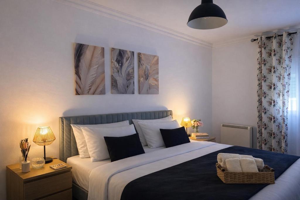 a bedroom with a bed and two paintings on the wall at Pink House - Lisbon in Lisbon