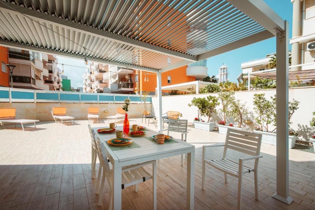 a patio with a table and chairs on a building at Velaria Boutique Apartment in Monopoli