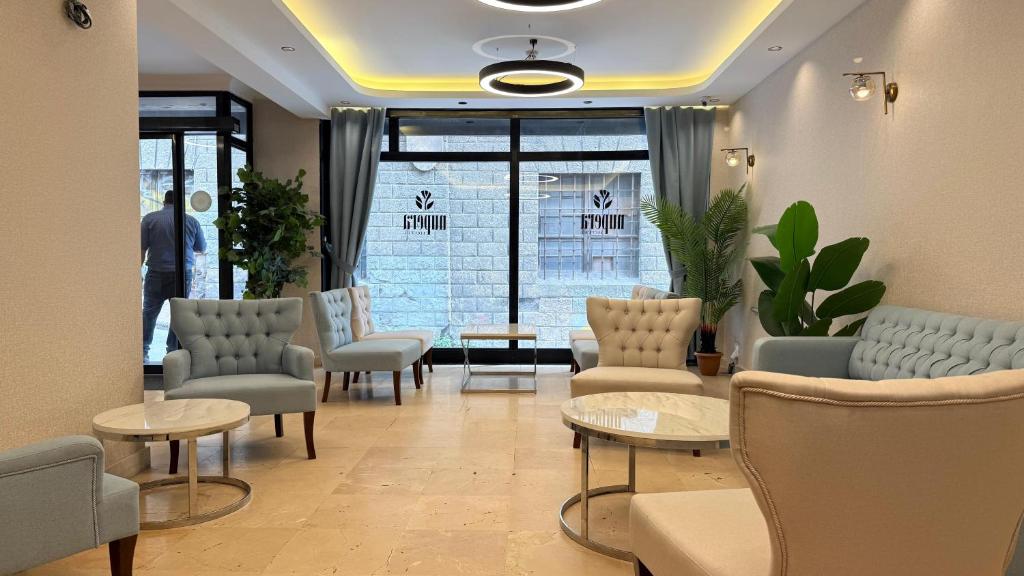a waiting room with chairs and tables and a window at Taksim Nu Pera Hotel in Istanbul