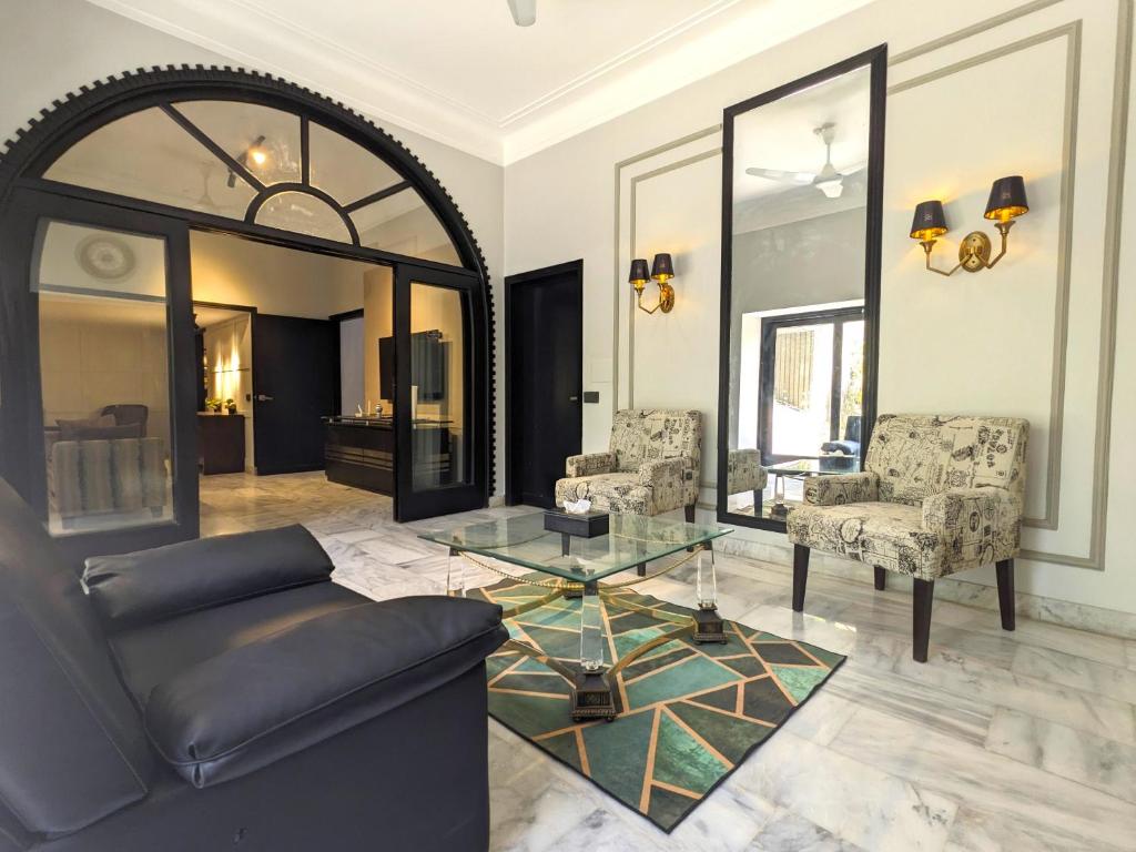 a living room with a couch and a glass table at Ghumo - 10BR Villa in Bahadurabad near Aga Khan in Karachi
