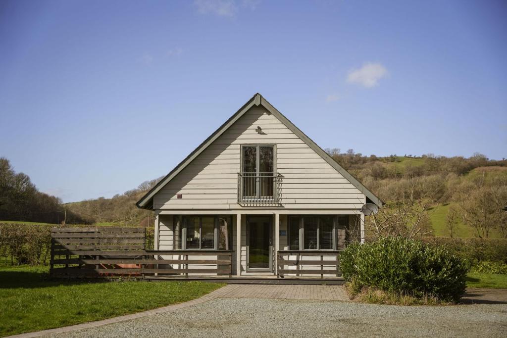 a white house with a window and a porch at Maple in Knighton
