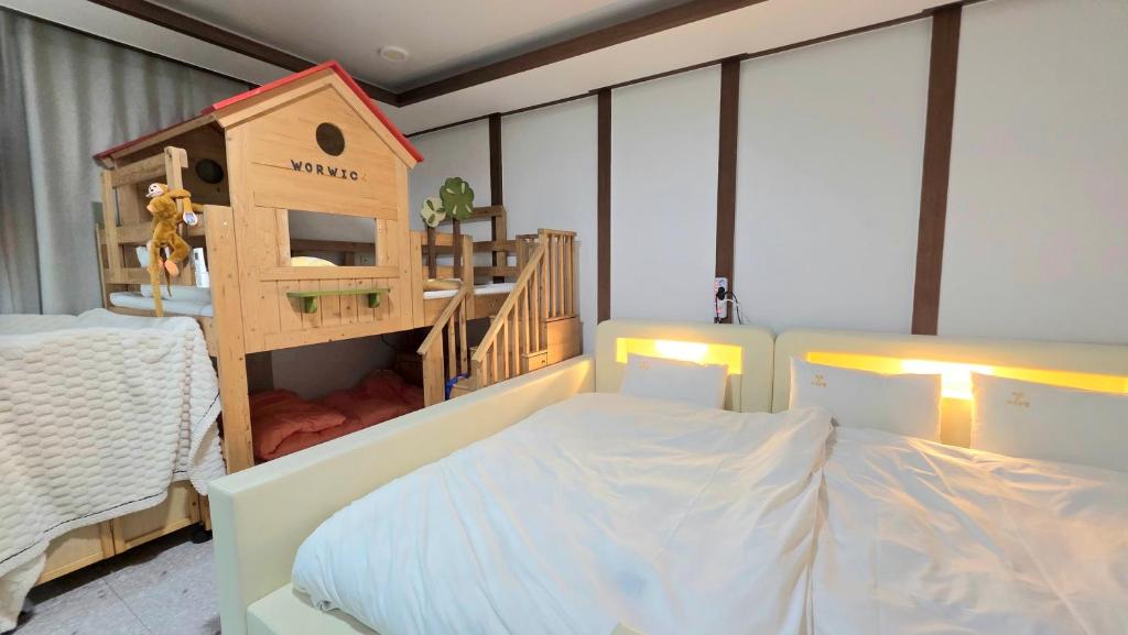 a bedroom with a bunk bed and a play house at Kids & Family Hotel in Gyeongju